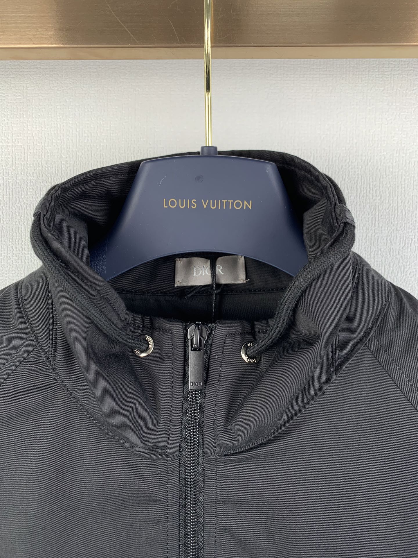 Dior hooded zip jacket with chin guard and adjustable draw cords at hood