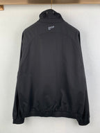 Back view of black Dior jacket with stand collar and small logo at upper back