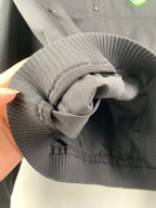 Ribbed hood opening and drawcord detail on a dark gray Dior jacket