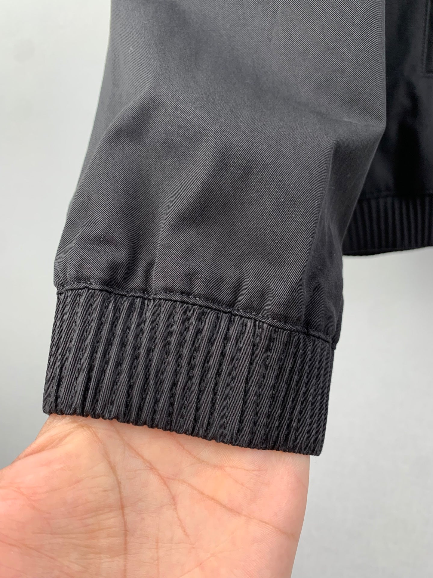Elastic ribbed cuff on a dark gray jacket sleeve