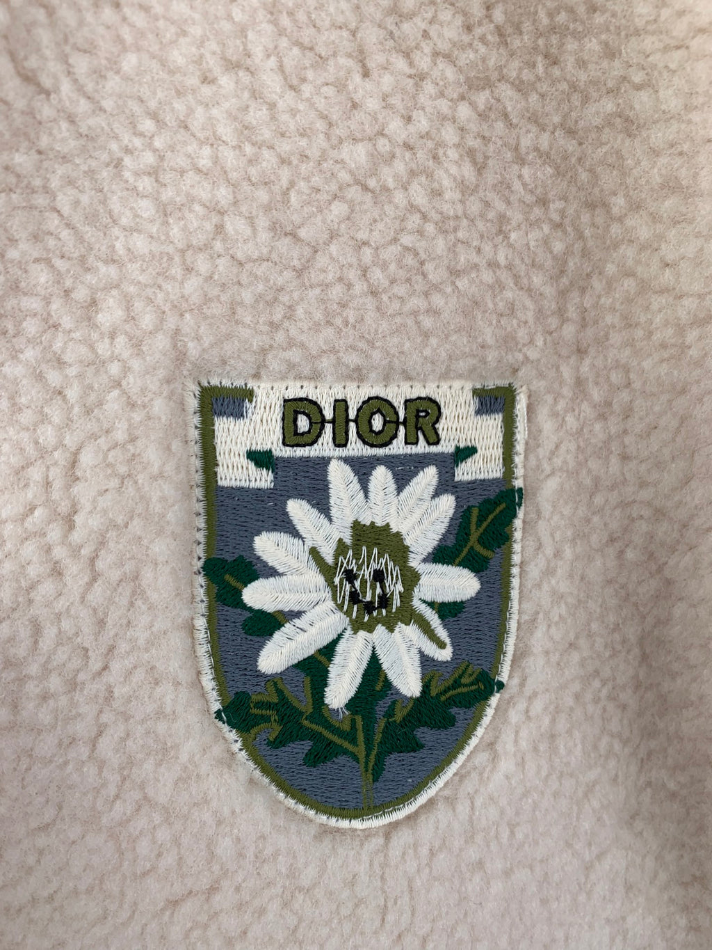 Ivory sherpa jacket crest patch with flower graphic