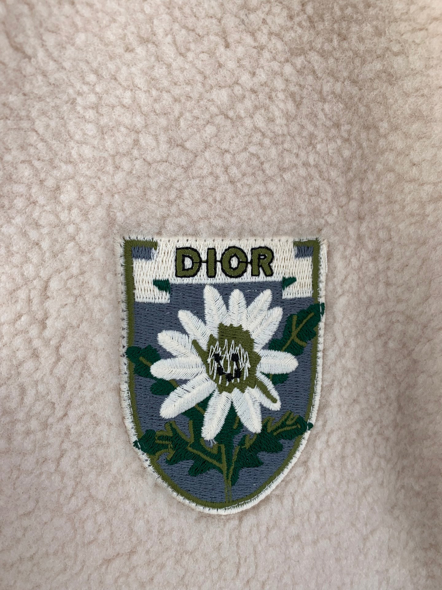 Ivory sherpa jacket crest patch with flower graphic