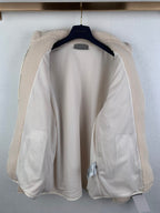 Ivory sherpa zip-up jacket interior lining with cuffs and collar visible