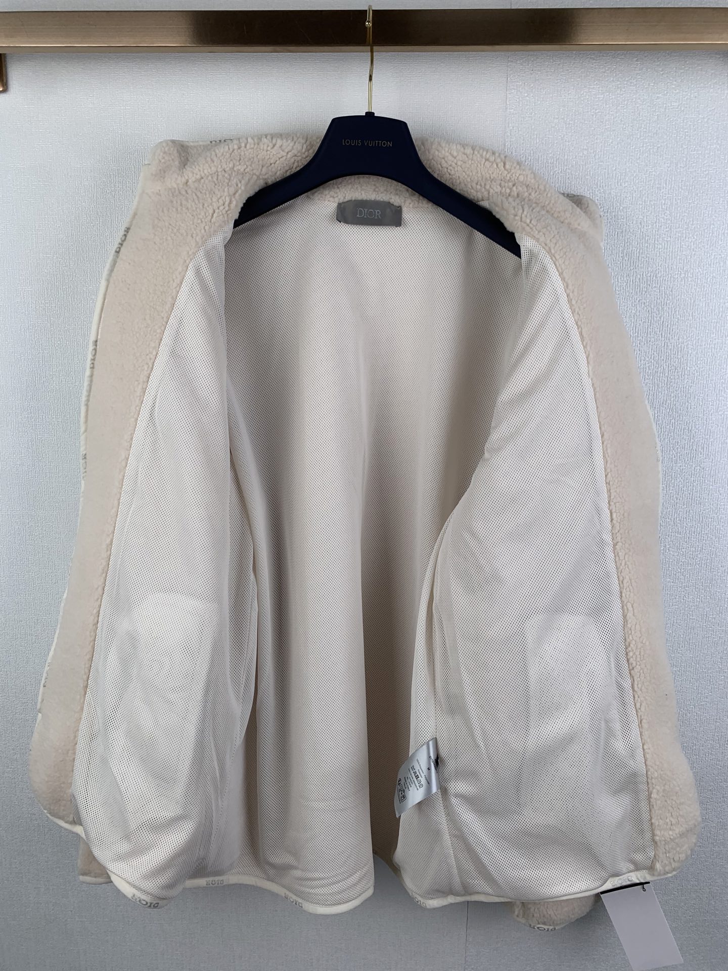 Ivory sherpa zip-up jacket interior lining with cuffs and collar visible