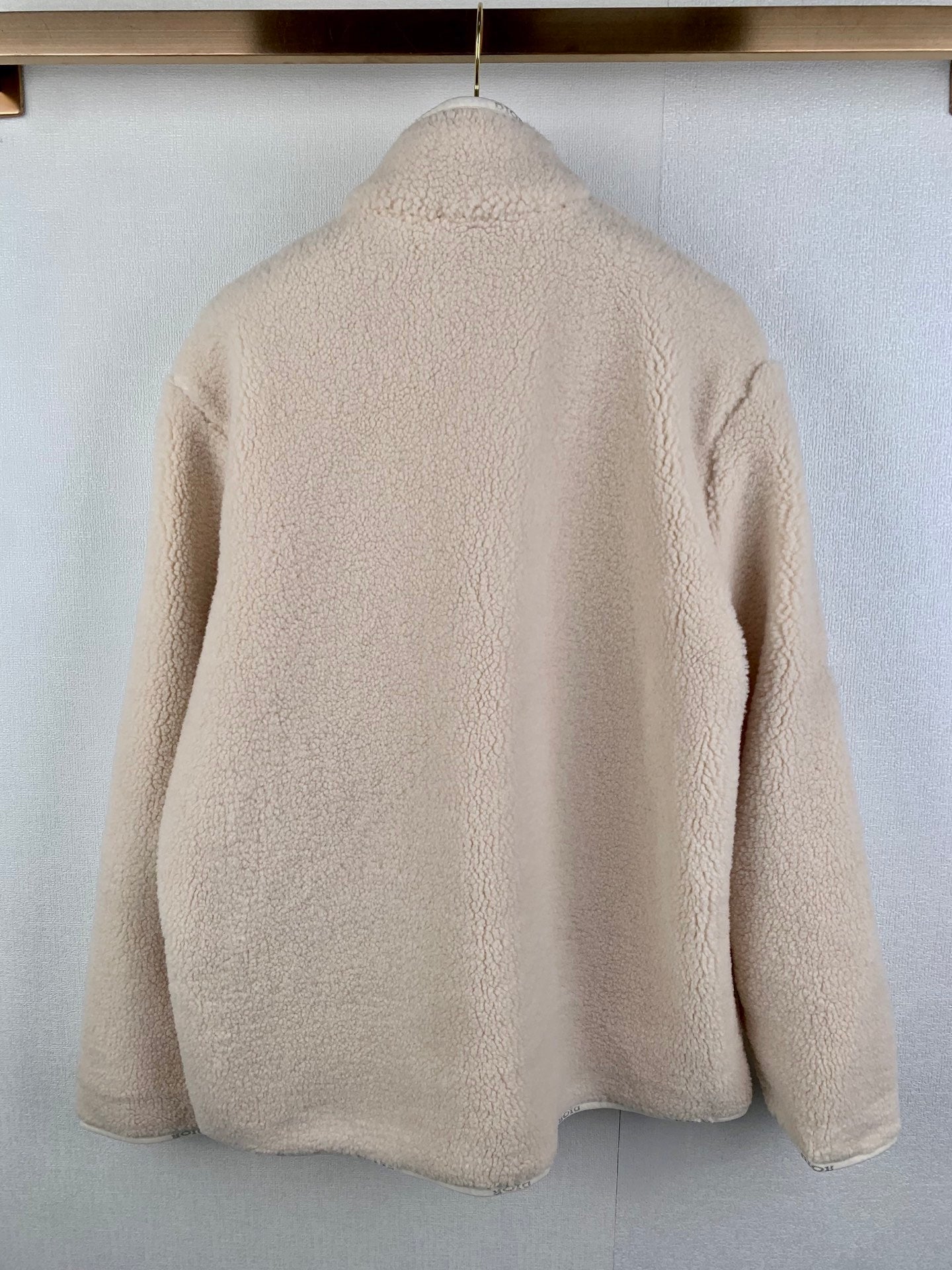 Cream sherpa zip-up jacket back view with full-length zipper