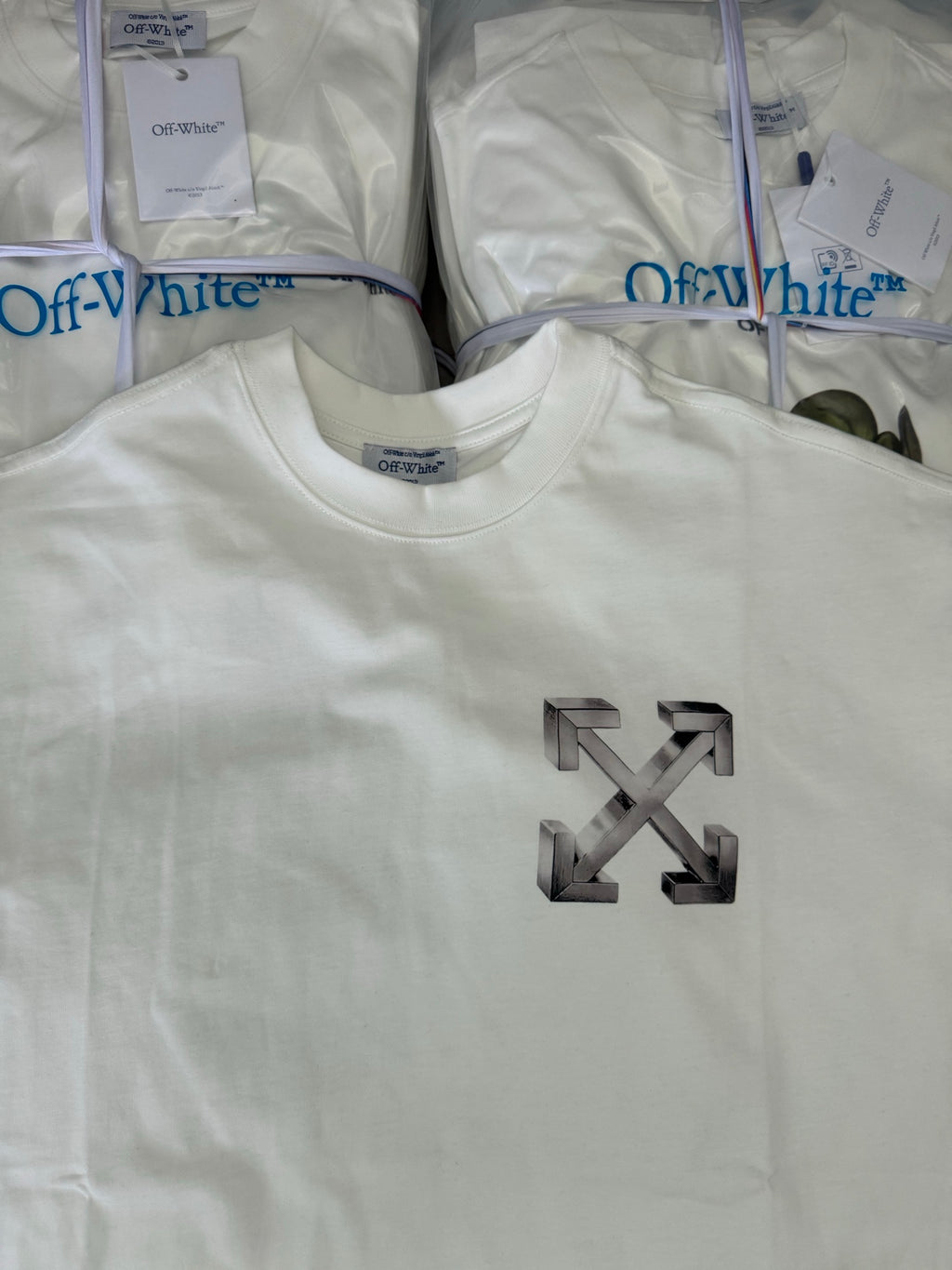 Off-white T-shirt with large metallic arrow X logo on front