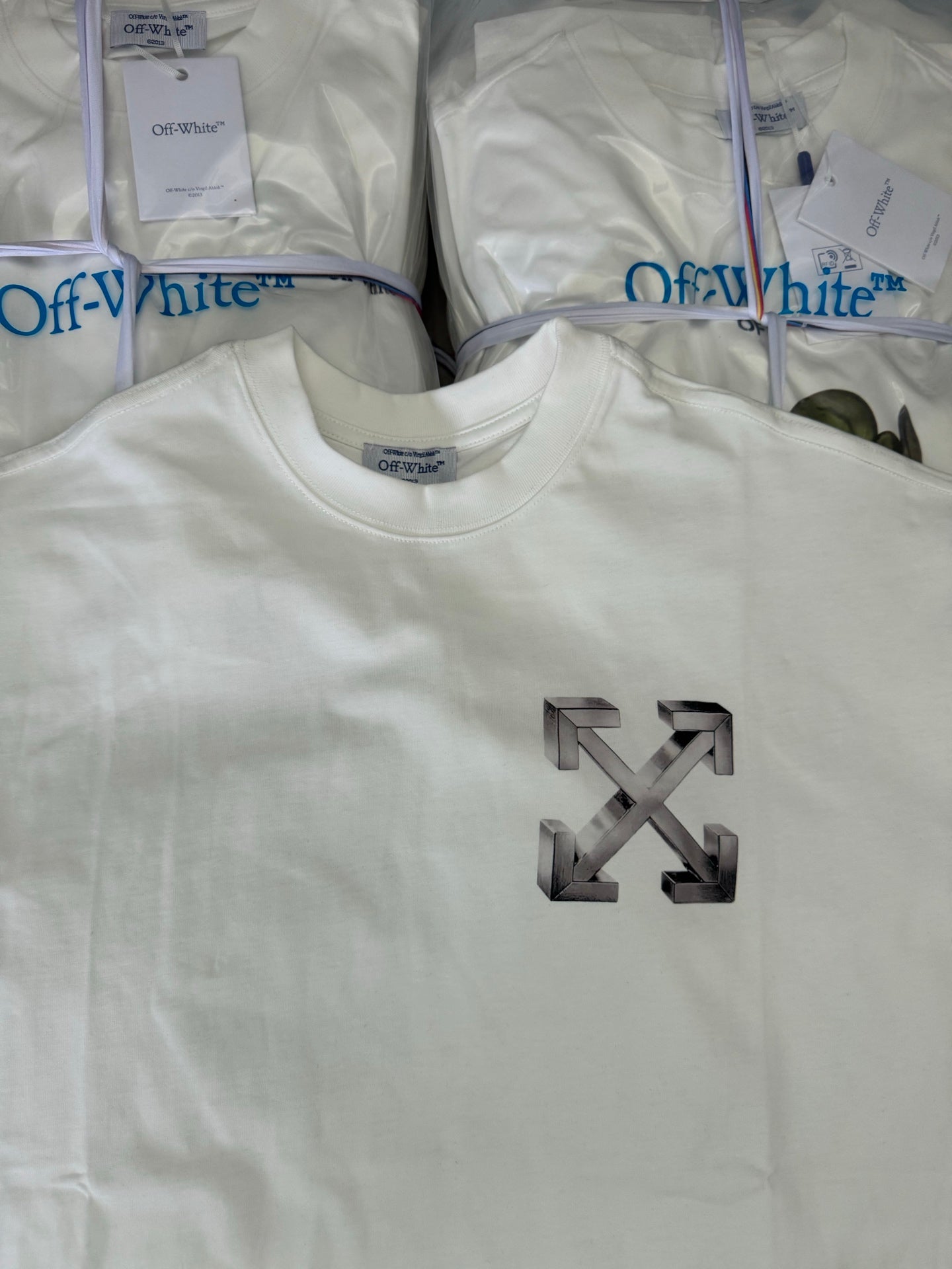 Off-white T-shirt with large metallic arrow X logo on front