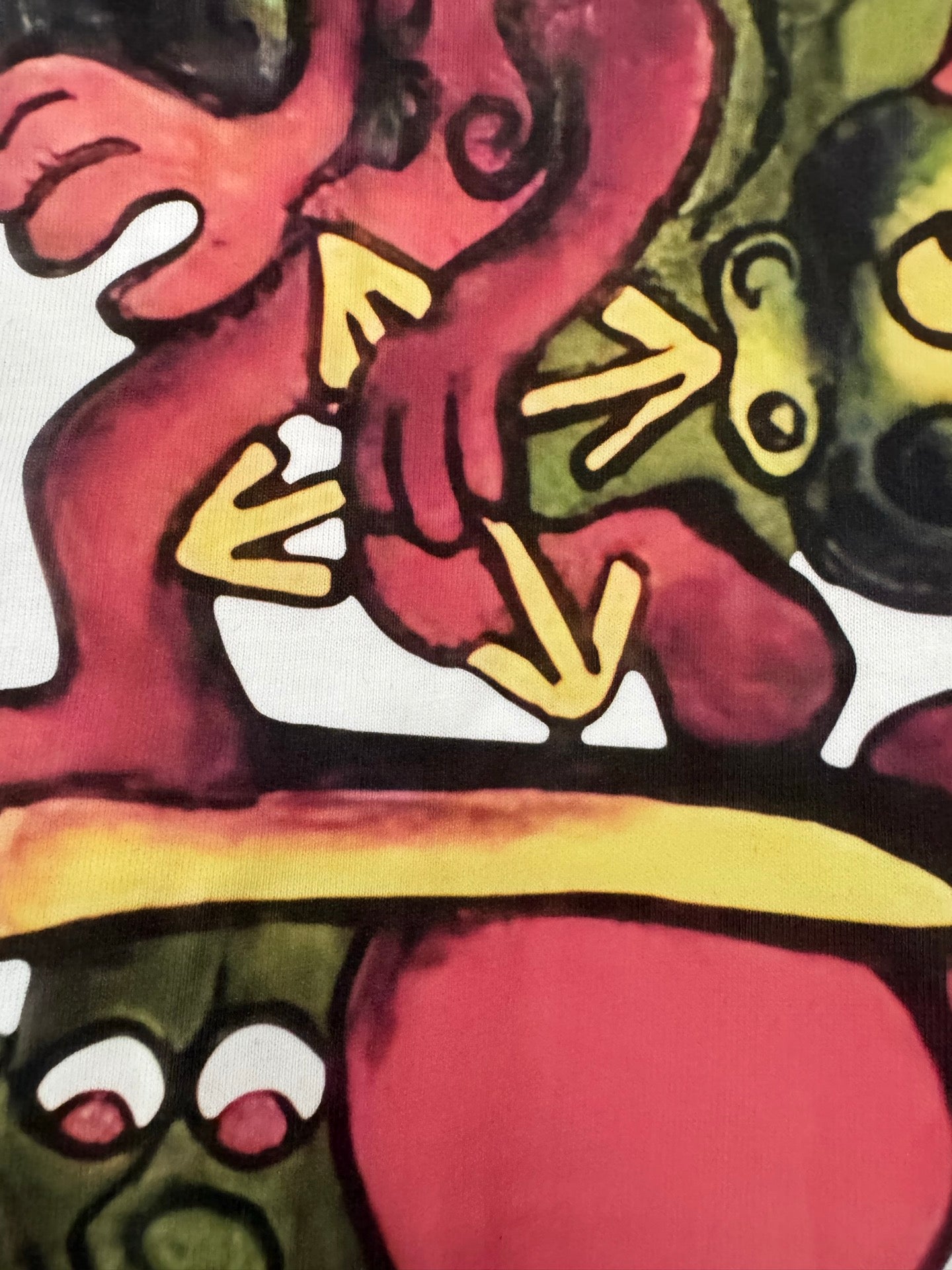 Off-white T-shirt close-up of colorful character hands and yellow platform