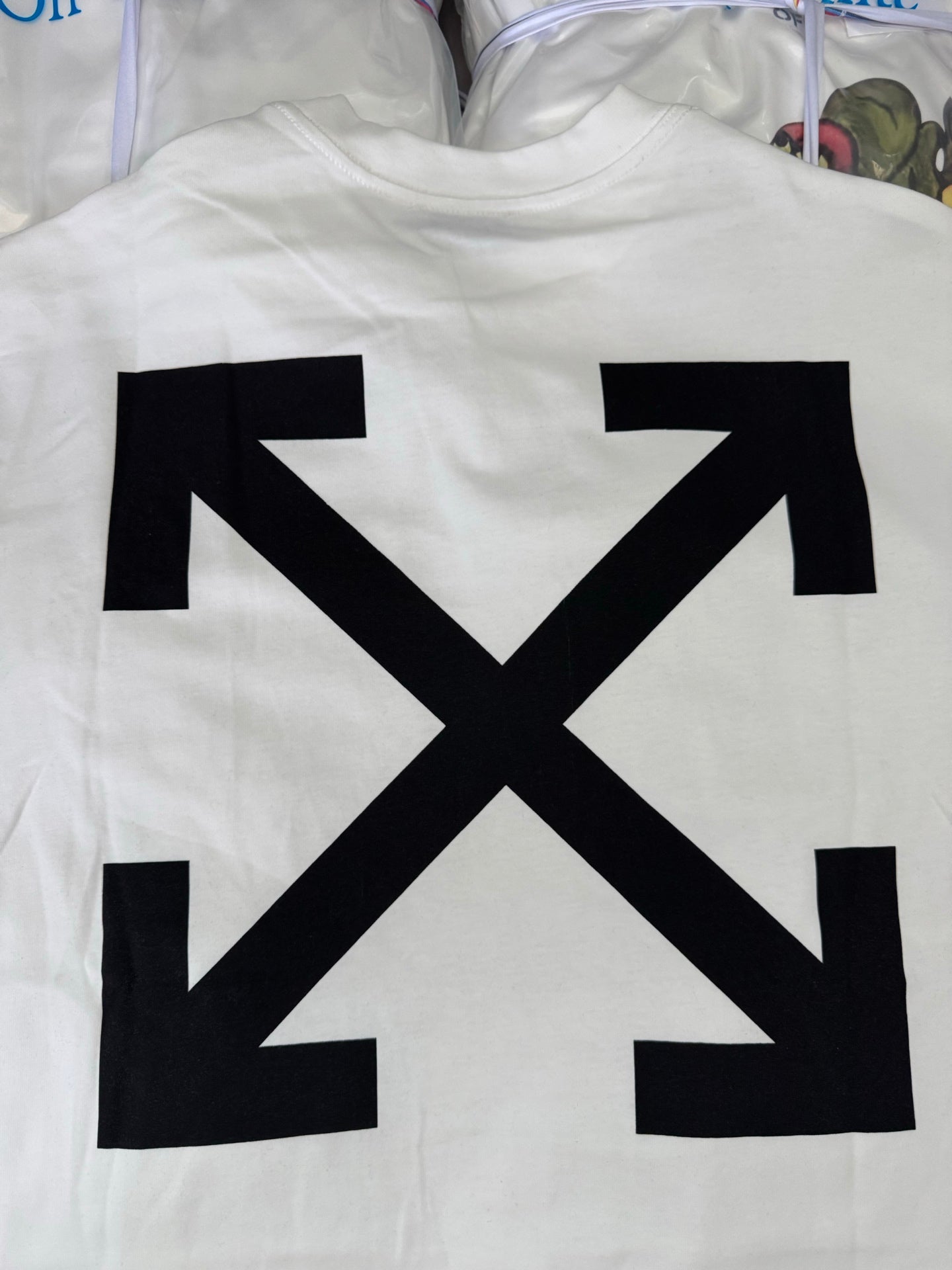 Off-white T-shirt back with bold black X arrow graphic