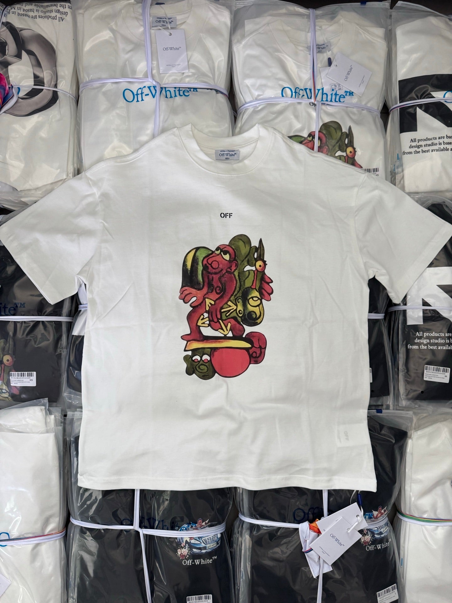 Off-white T-shirt with small OFF text and colorful character graphic