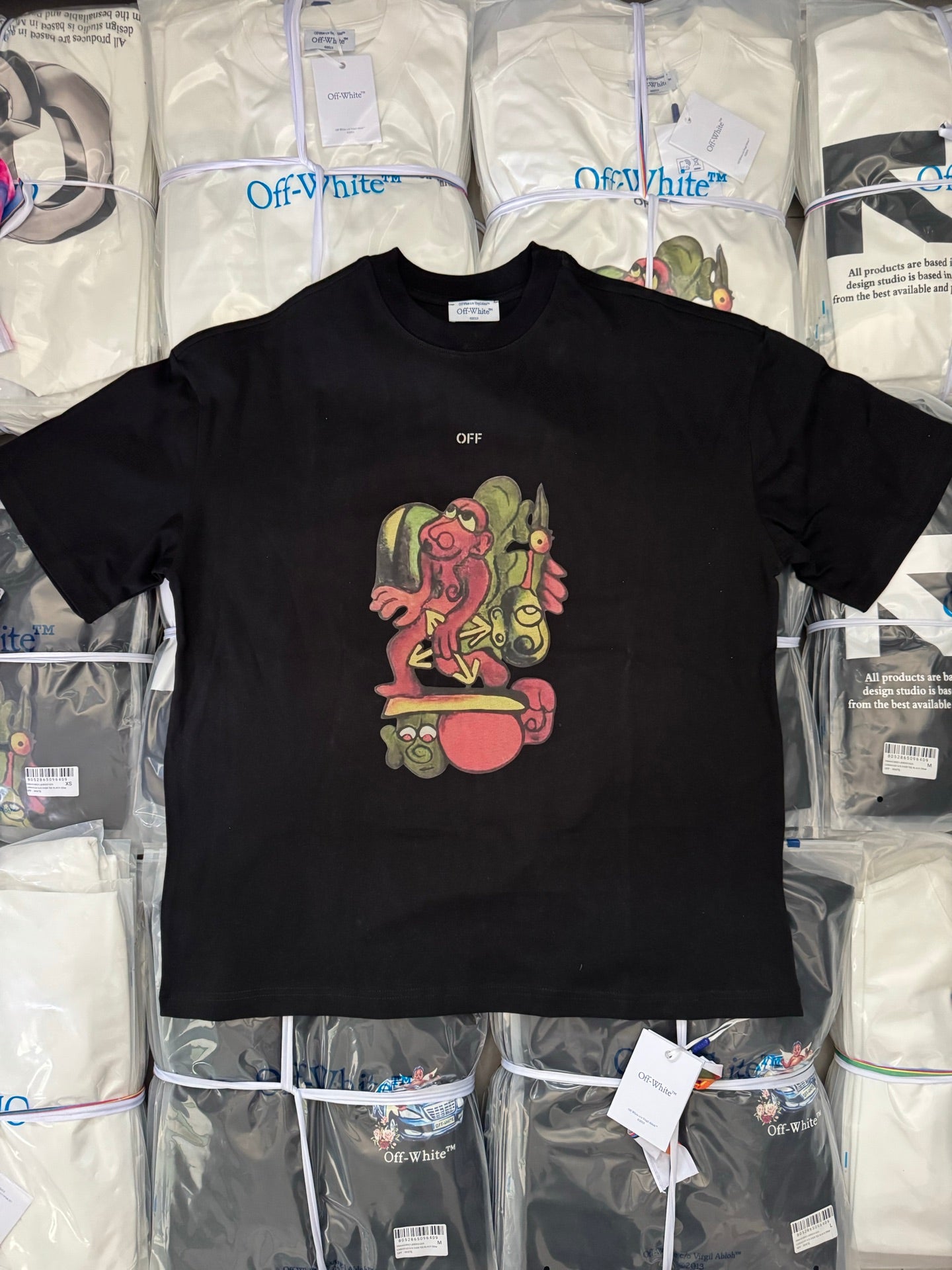 Black T-shirt with colorful cartoon graphic and small OFF text