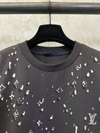 Black crewneck T-shirt with scattered white motif print, neckline close-up