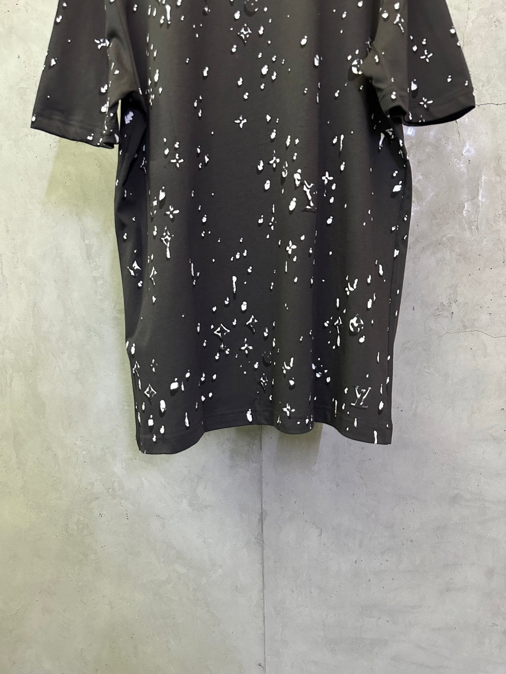 Black short-sleeve T-shirt with scattered white motif print, back view