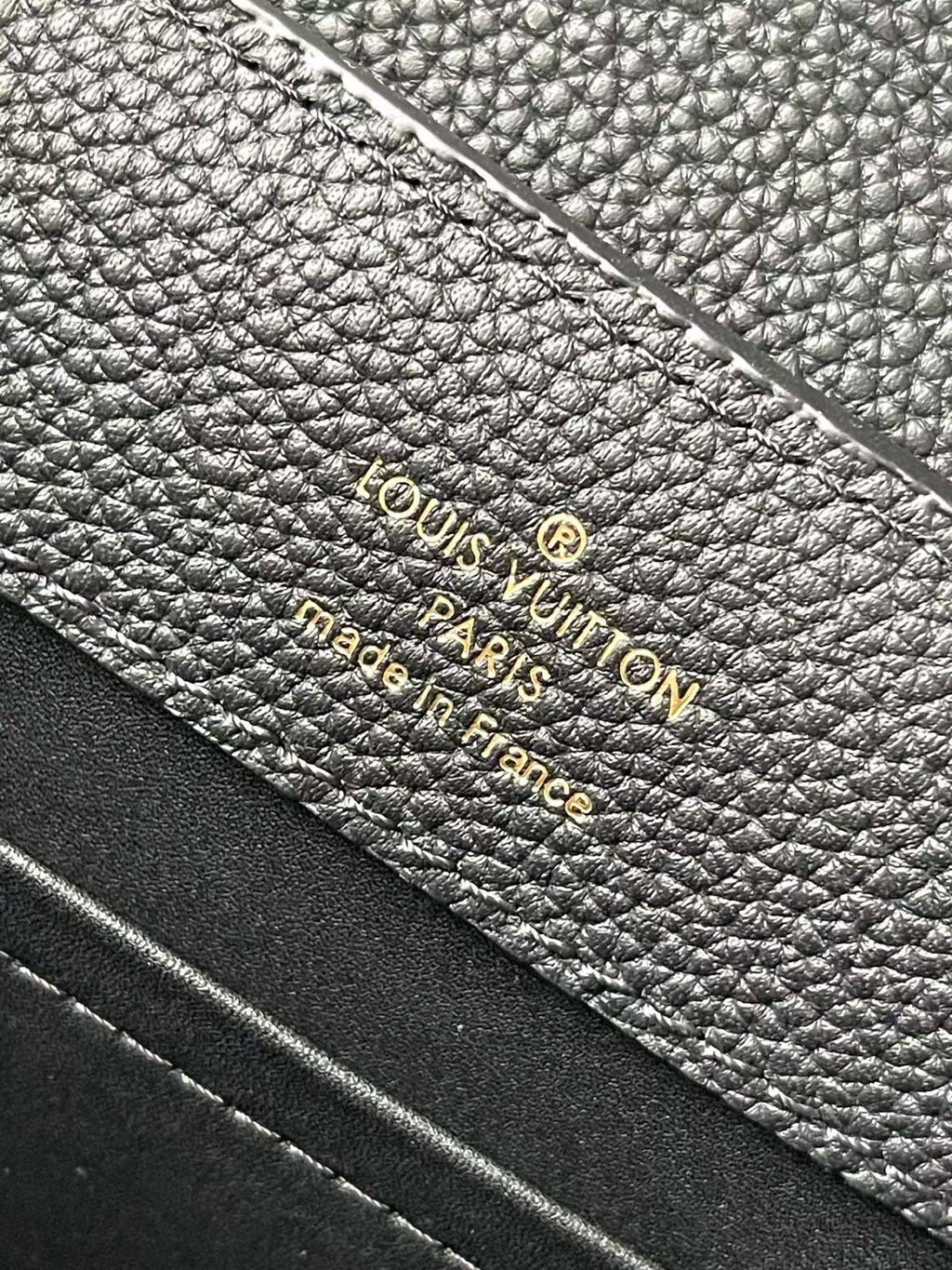 Louis Vuitton Paris France label on textured navy leather lining