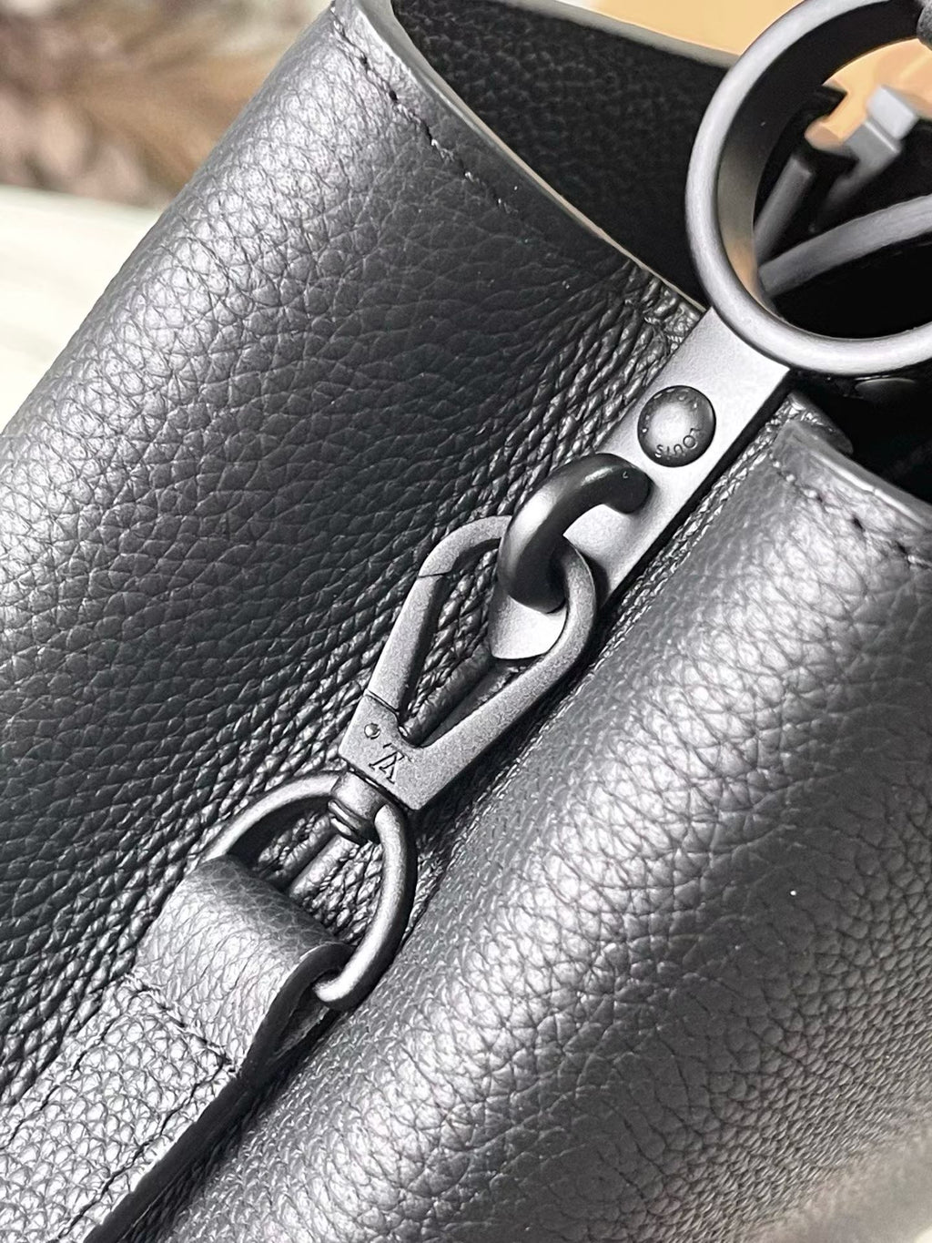 Close-up of navy leather bag clasp and metal ring hardware