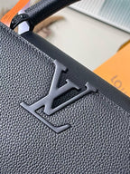 Close-up of Louis Vuitton LV monogram on textured navy leather