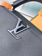 Dark leather handbag with embossed LV monogram on textured front panel