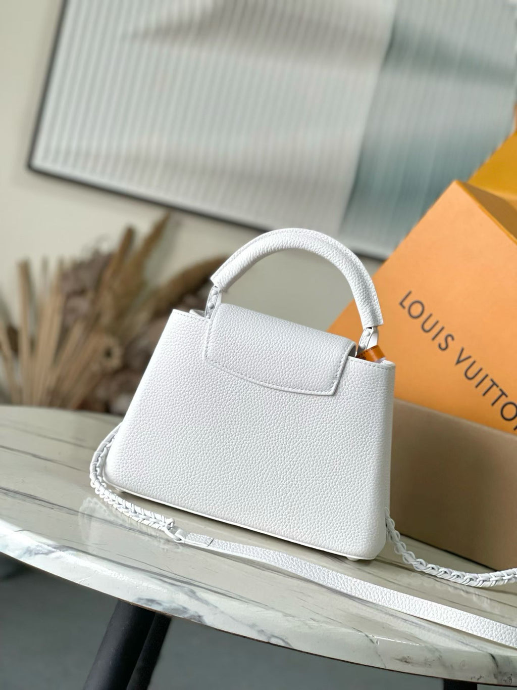 Louis Vuitton small leather handbag, white textured leather with front handle and emblem