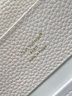 Louis Vuitton logo patch on white textured leather