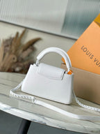 White mini handbag with top handle and long chain strap, logo front panel