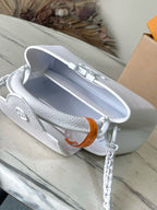 White mini handbag open top with embossed logo tab inside and chain strap