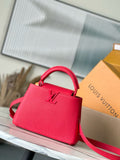 Red leather handbag with top handle and crossbody strap, Louis Vuitton