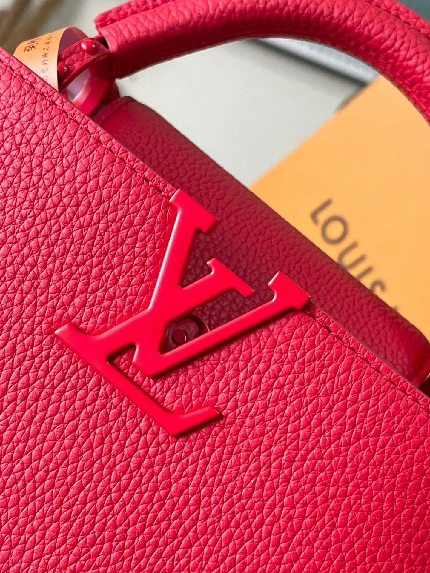 Louis Vuitton red leather handbag LV logo embossed on textured leather
