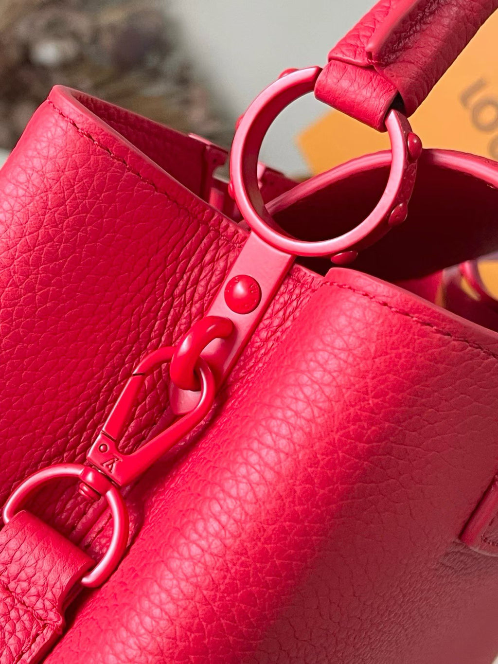 Red leather handbag with D-ring hardware and snap closure, Louis Vuitton