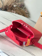 Red leather mini handbag open with zip pocket and fabric lining