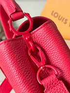 Red leather handbag with metal ring detail and shoulder strap