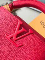 Red textured leather handbag with large embossed LV-style emblem