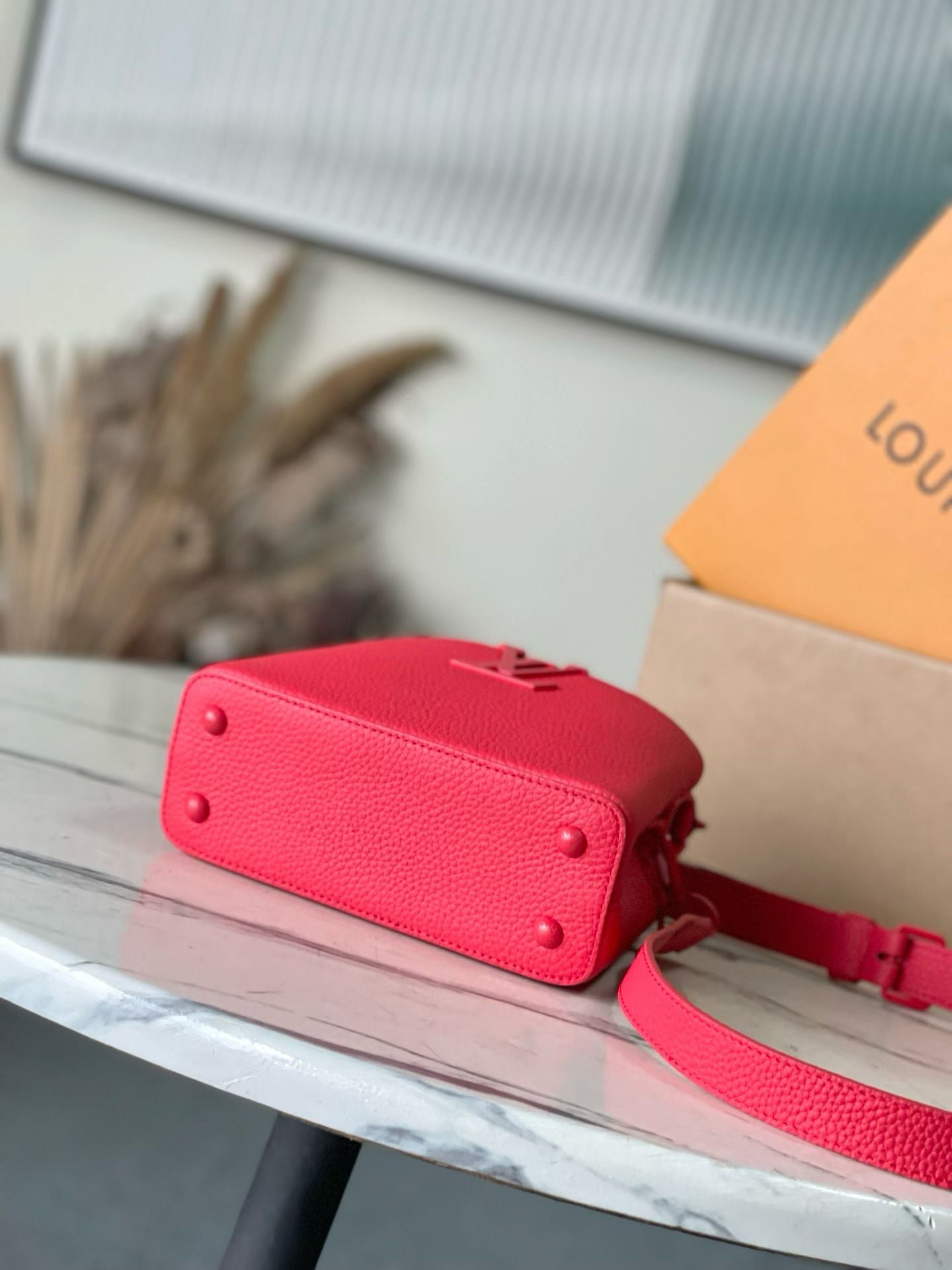 Red leather mini handbag back with side stud details and strap attachment