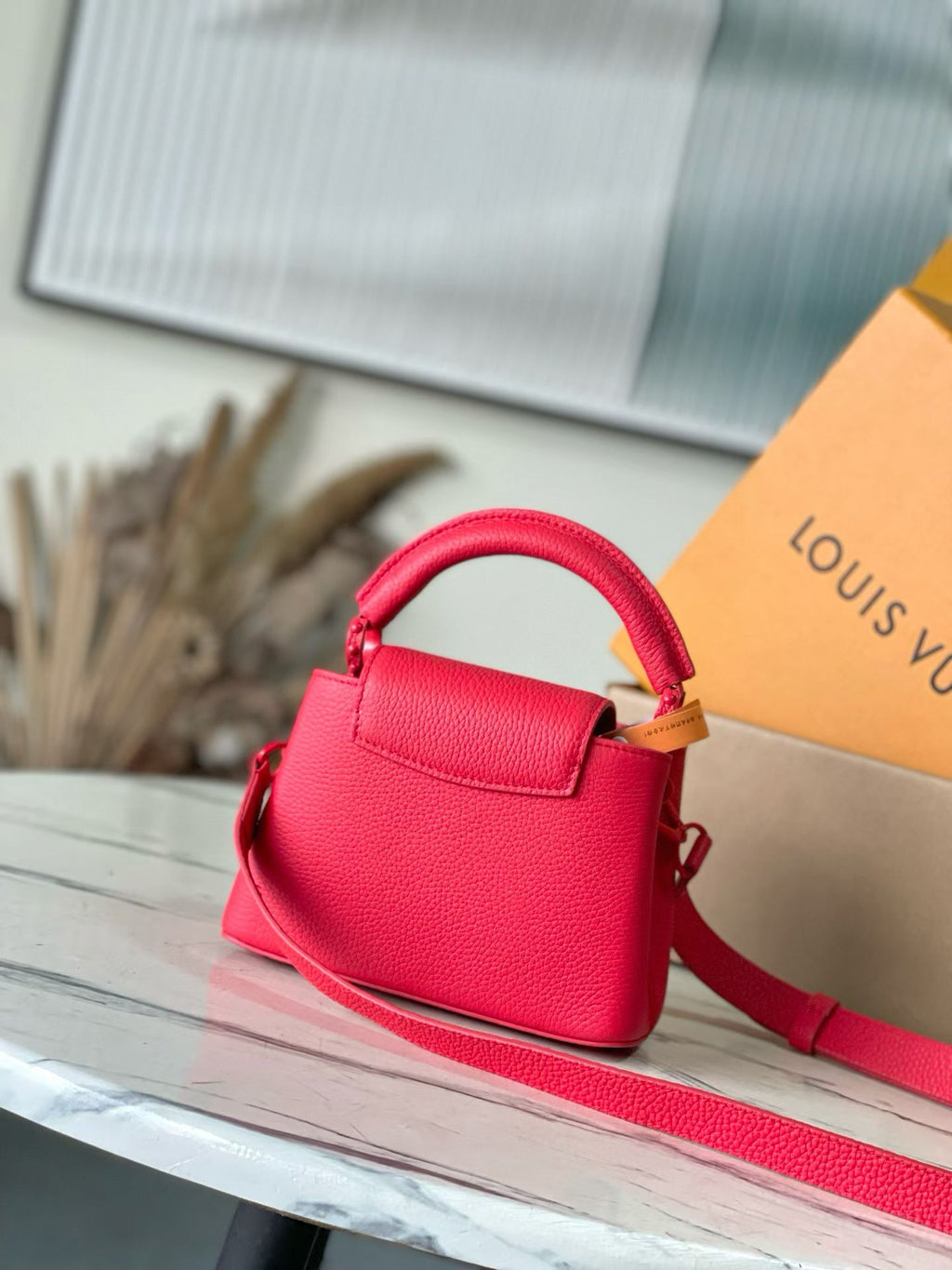 Red leather mini handbag with top handle and structured front