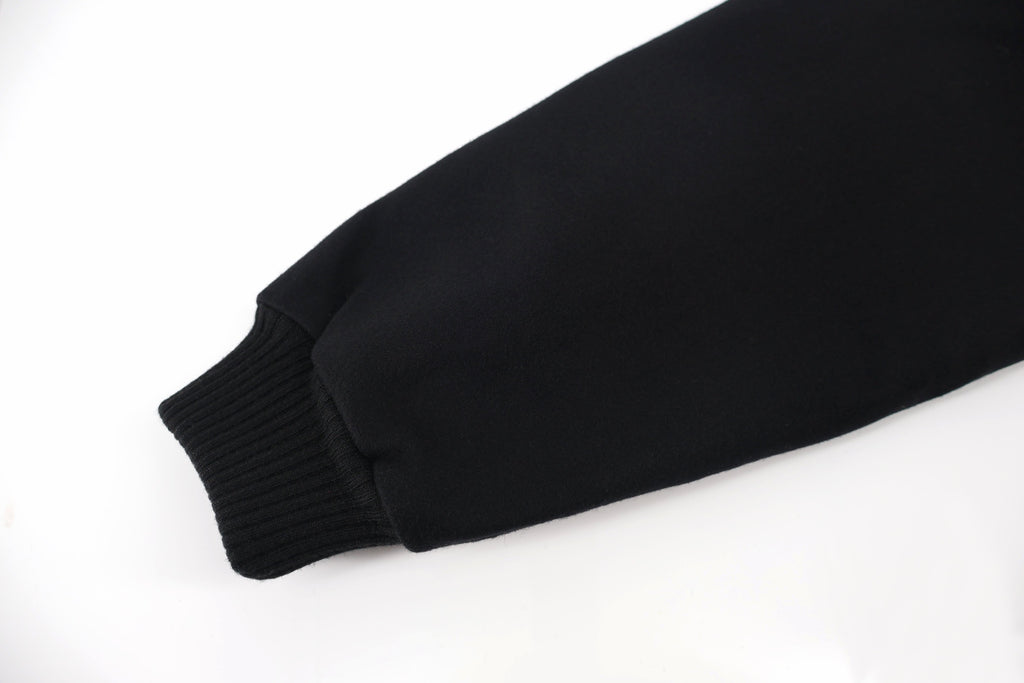 Black jacket sleeve end with ribbed knit cuff