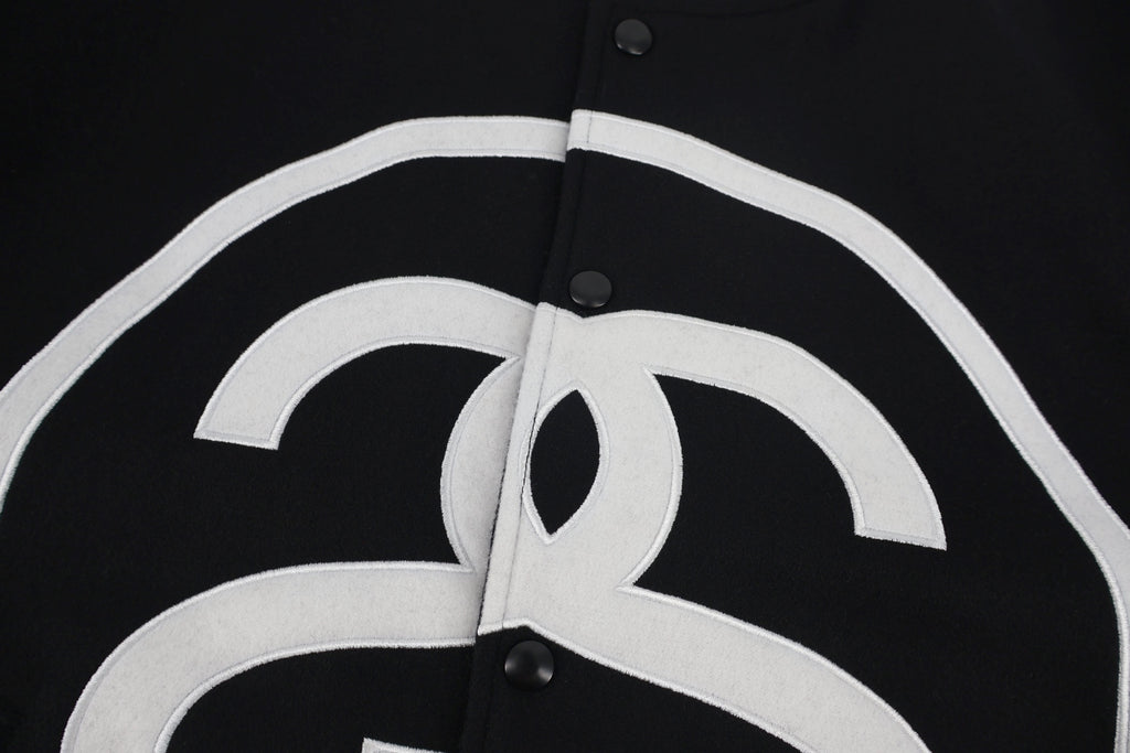 Black jacket chest panel with white outlined logo detail