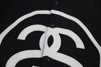 Black jacket chest panel with white outlined logo detail