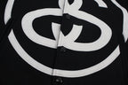 Black jacket front with oversized white double C emblem