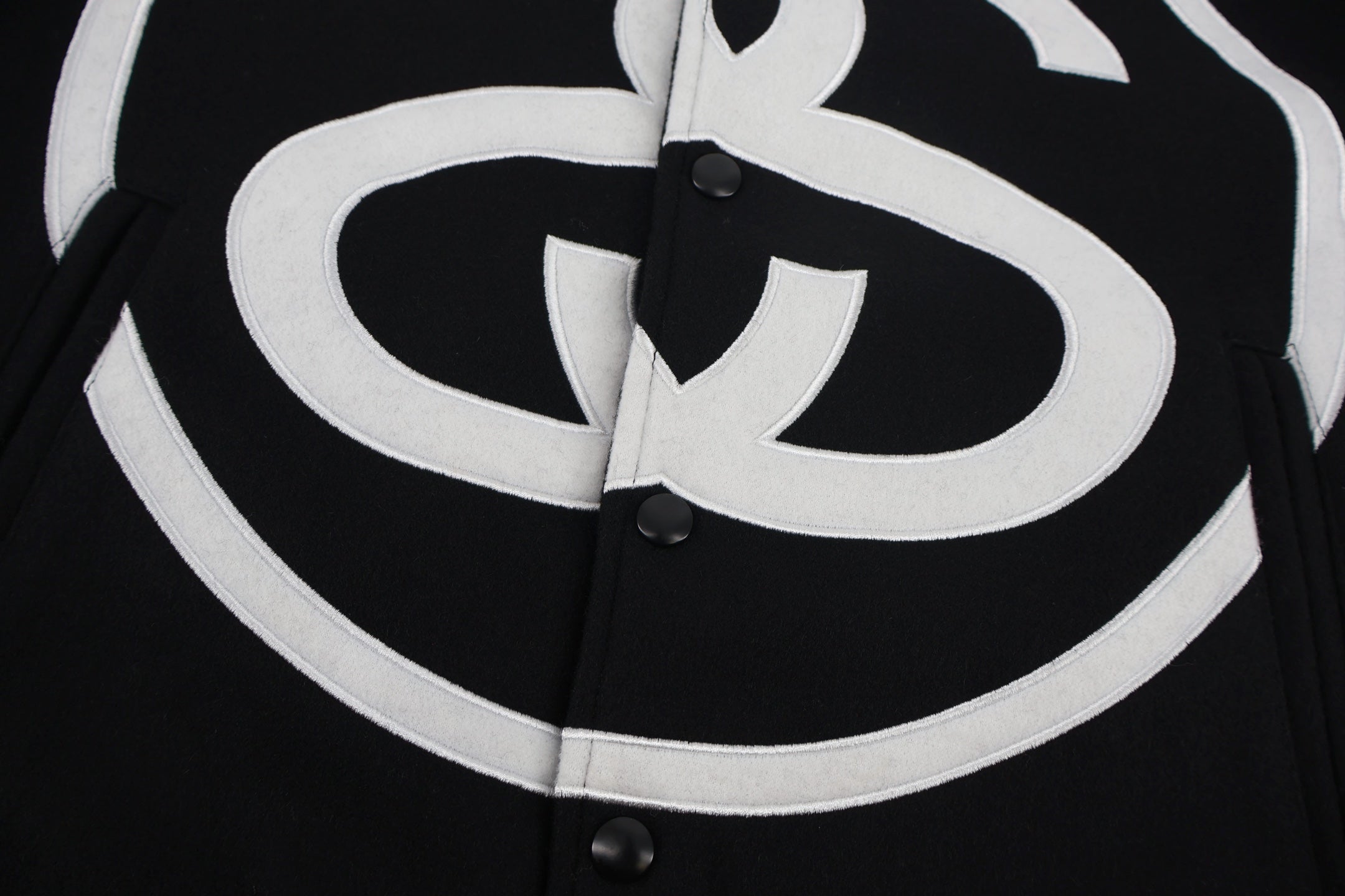 Black jacket front with oversized white double C emblem