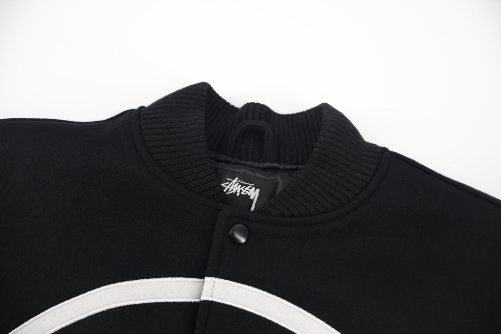 Black ribbed knit collar with snap placket and Stussy logo