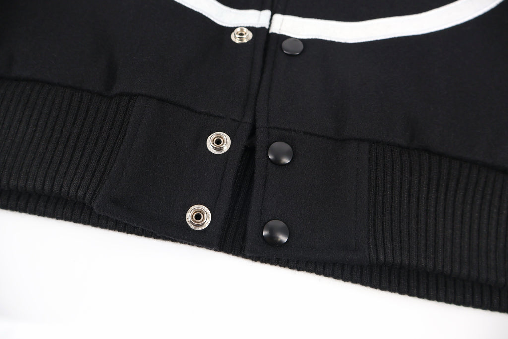 Black jacket waistband with ribbed hem and snap button placket