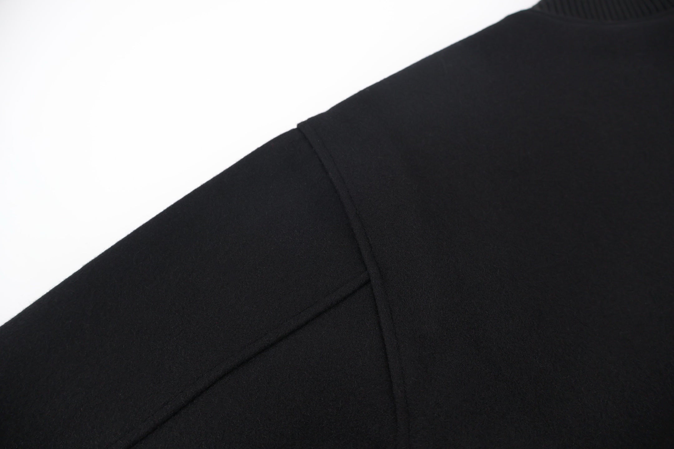 Black jacket sleeve with side seam and smooth knit cuff