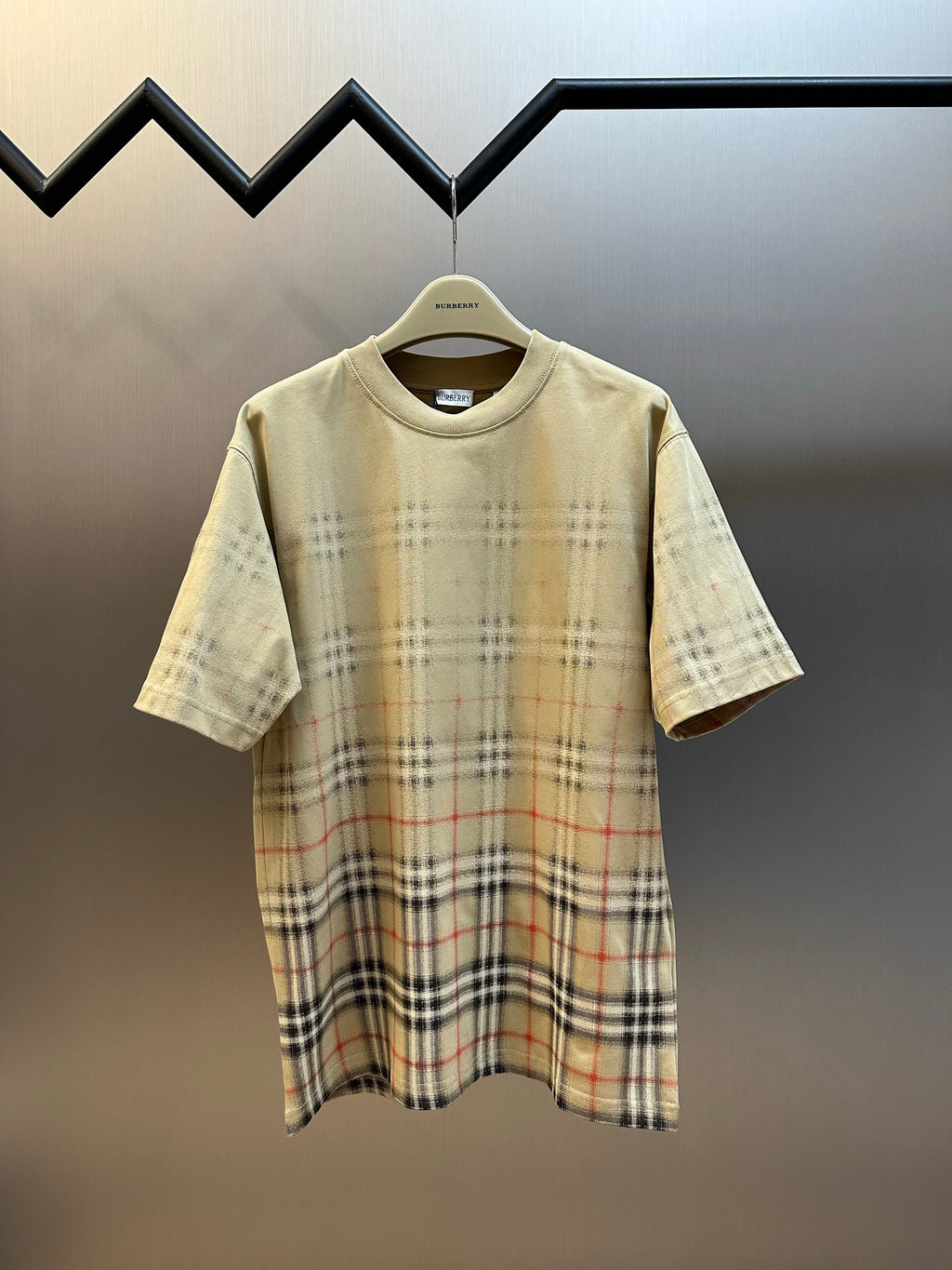 Beige short-sleeve shirt with crew neck and check plaid lower panel