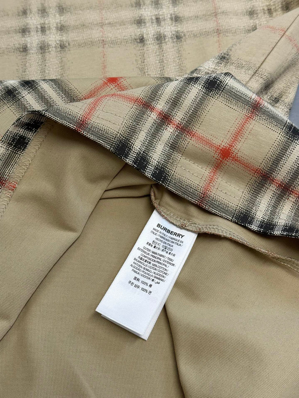 Beige shirt with check plaid cuff and interior care label
