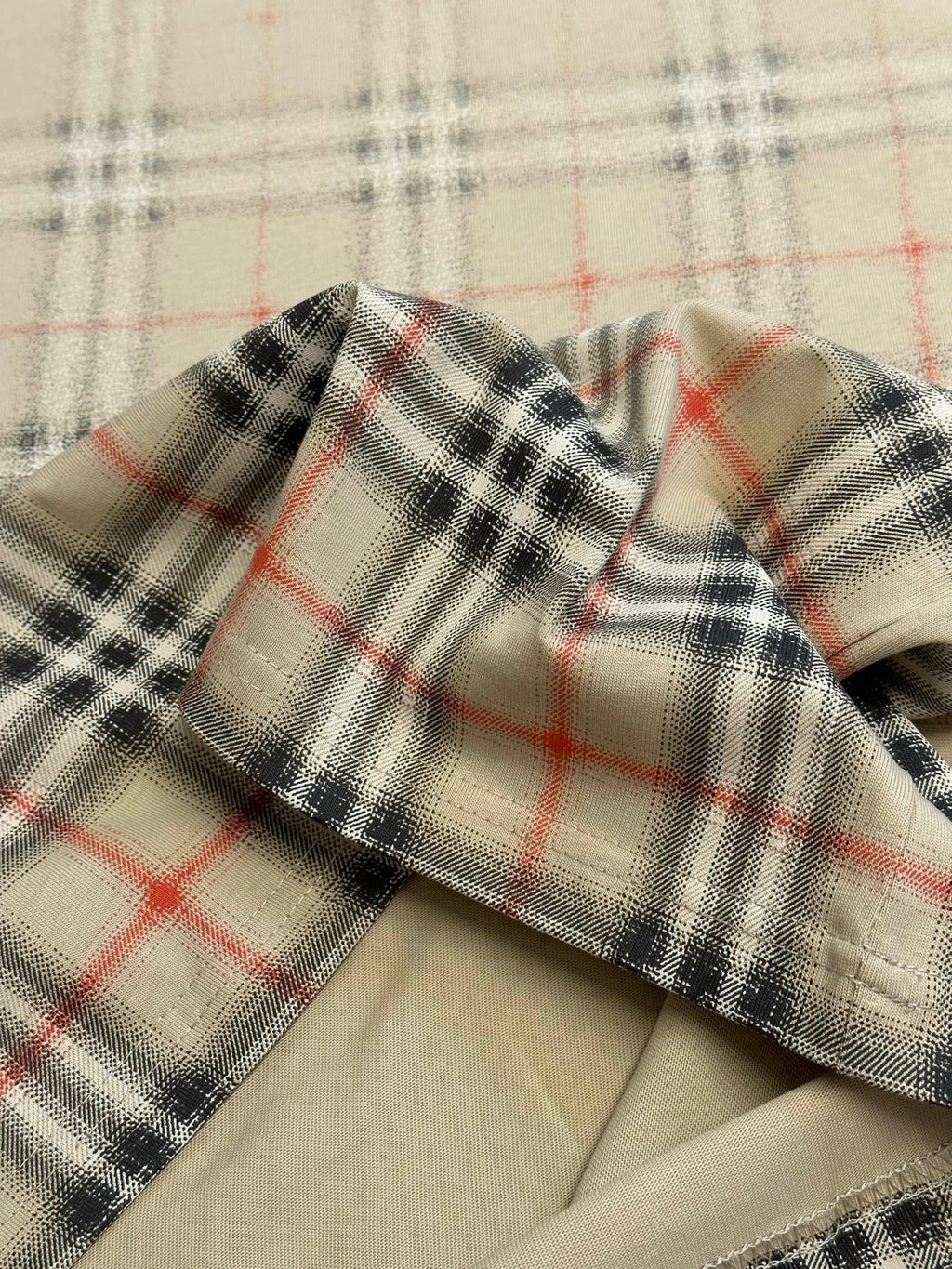 Beige collar edge with red and dark check plaid fabric trim