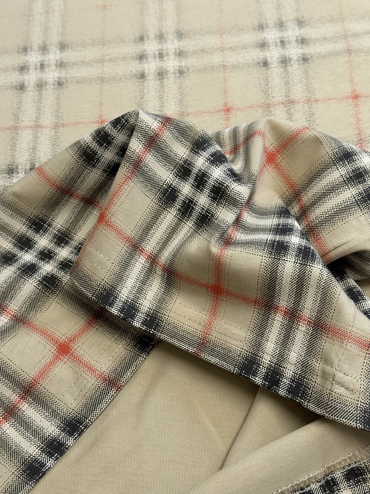 Beige collar edge with red and dark check plaid fabric trim