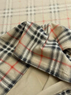 Plaid fabric sleeve cuff on a beige short-sleeve top
