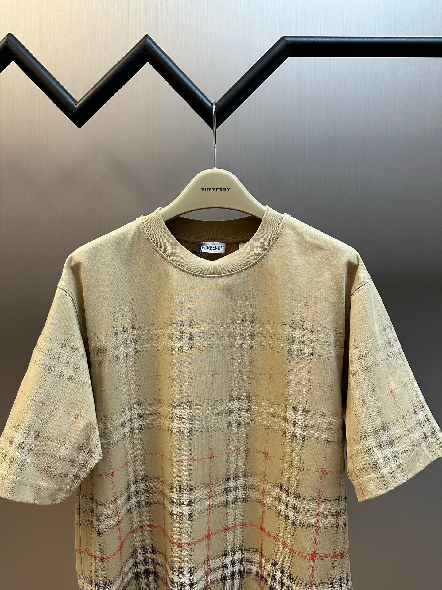 Beige short-sleeve shirt with crew neck and check plaid all-over lower area
