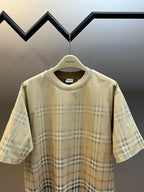Beige short-sleeve crew-neck top with plaid print from chest to hem