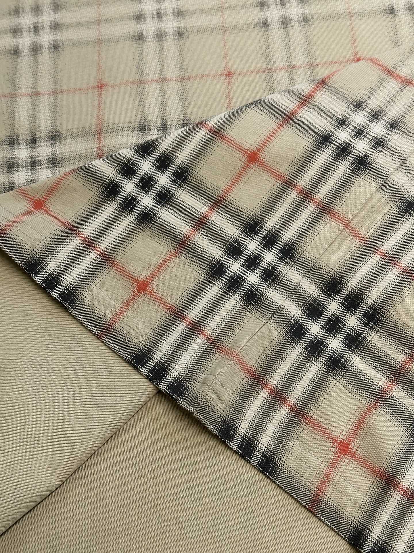 Close-up of beige fabric with red and dark check plaid hem edge