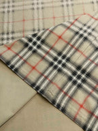 Plaid hem panel on beige short-sleeve top